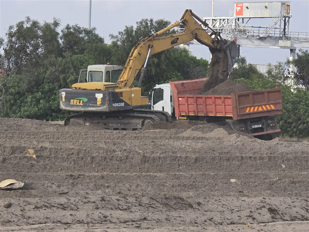 Excavator loading a tipper truck on site