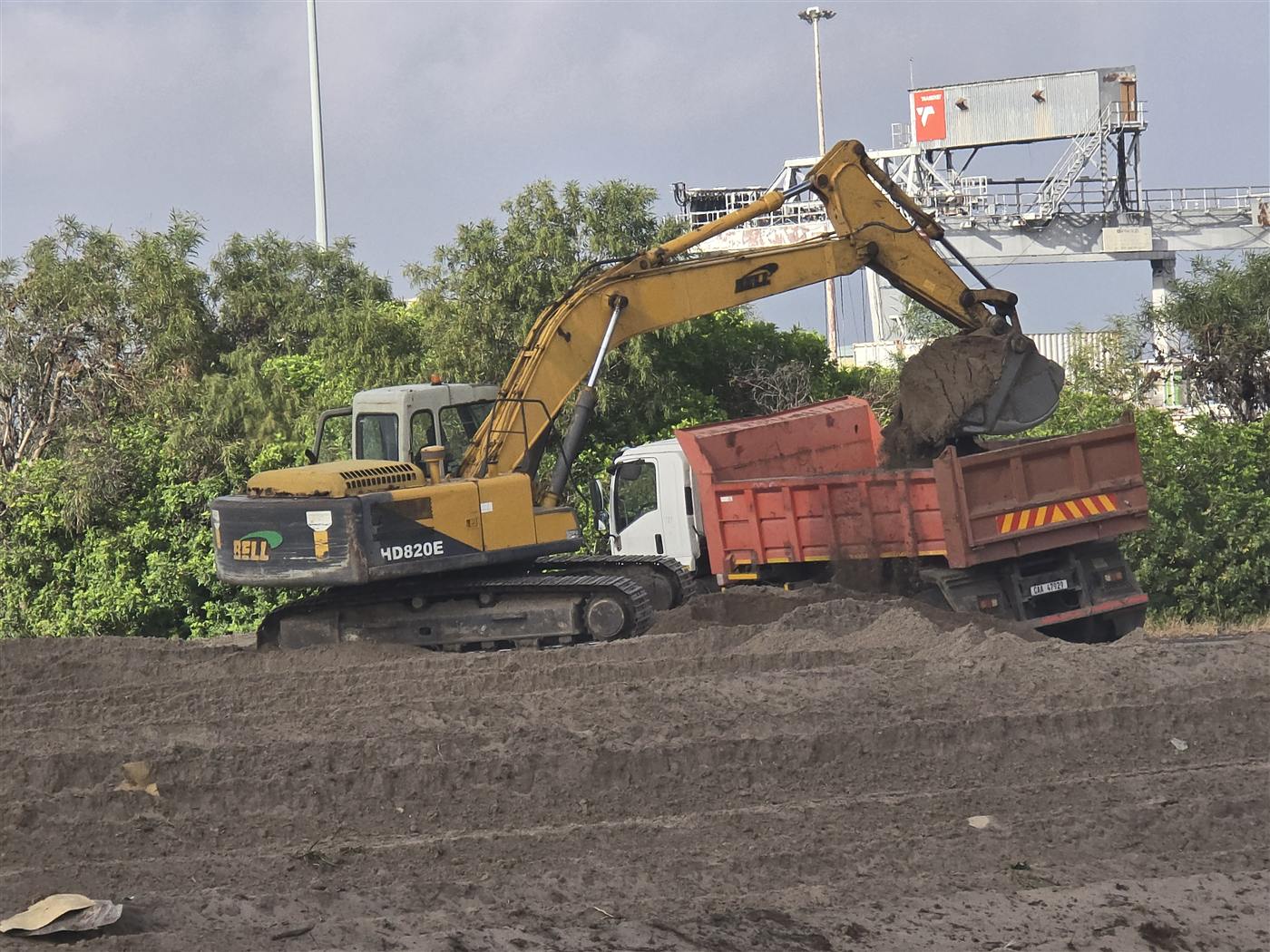 Excavator loading a tipper truck on a Cape Town site