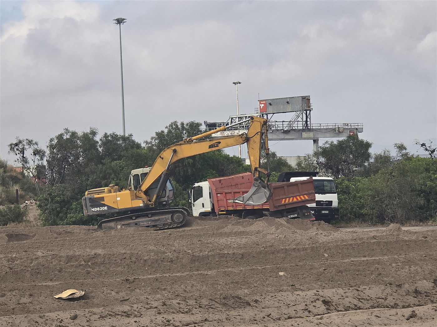 Excavator loading a tipper truck on a Cape Town site