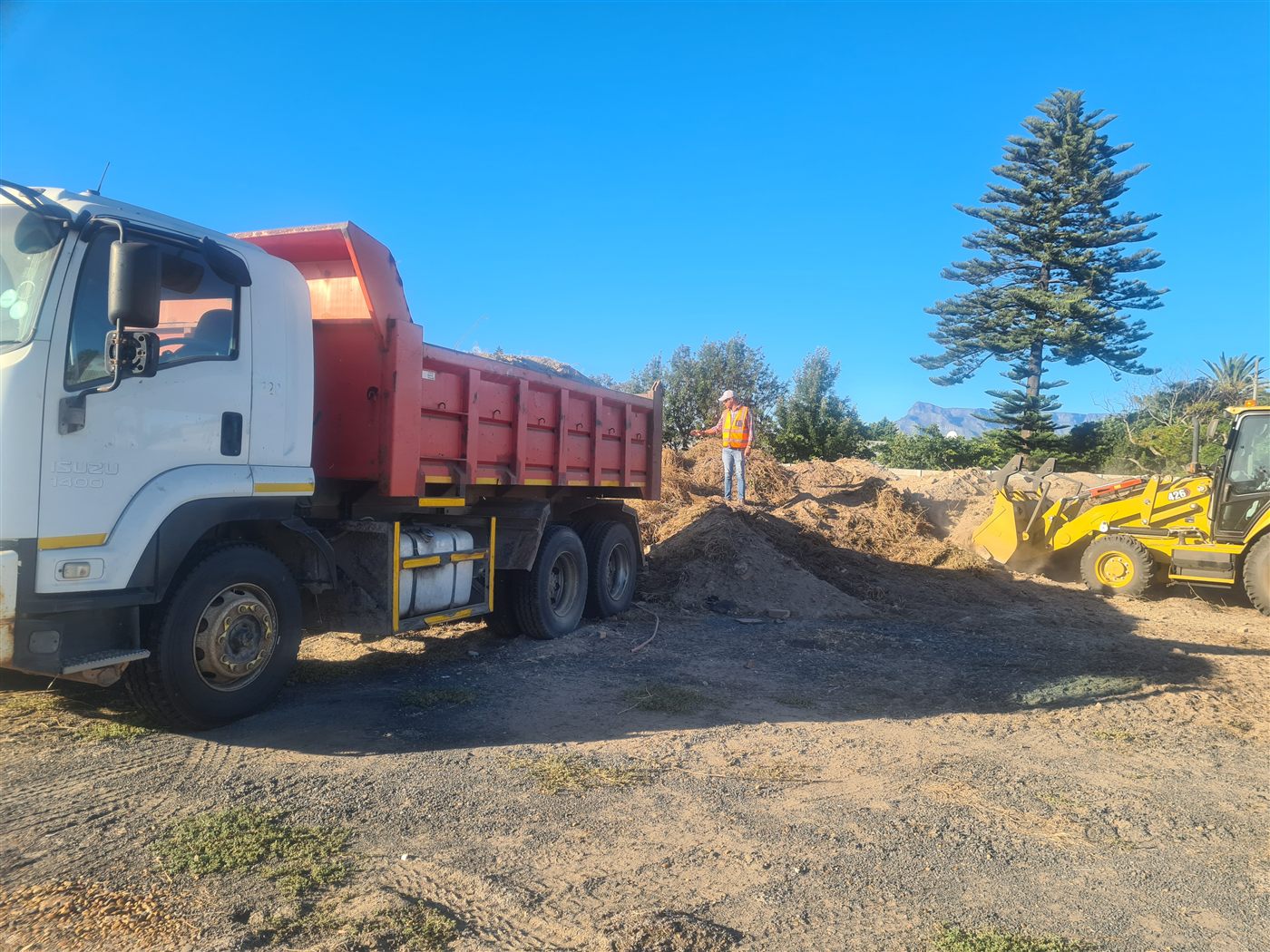 U&F Removals 10-tonne tipper truck tipping a load with Table Mountain in the background