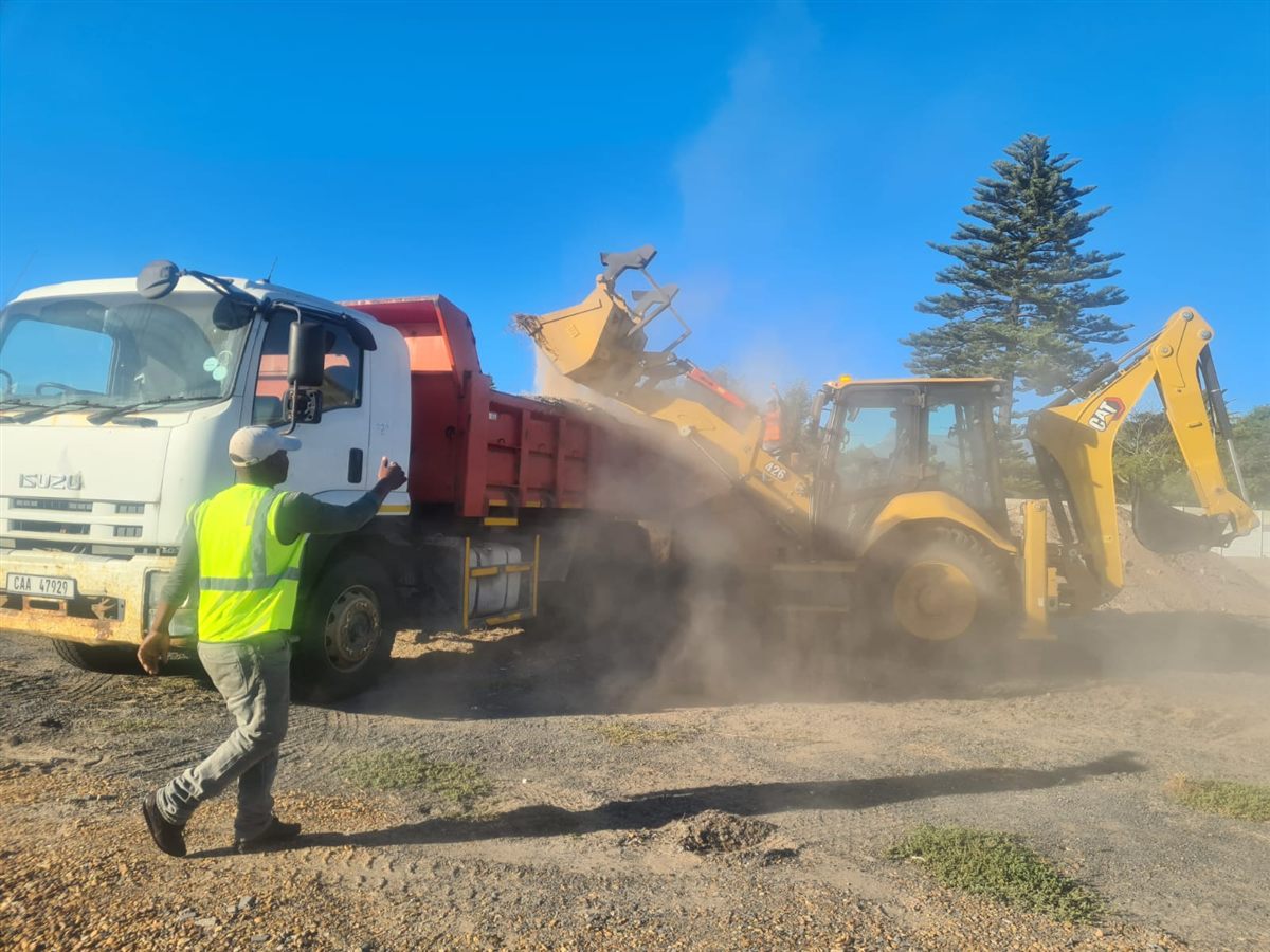 Tipper truck being loaded by an excavator